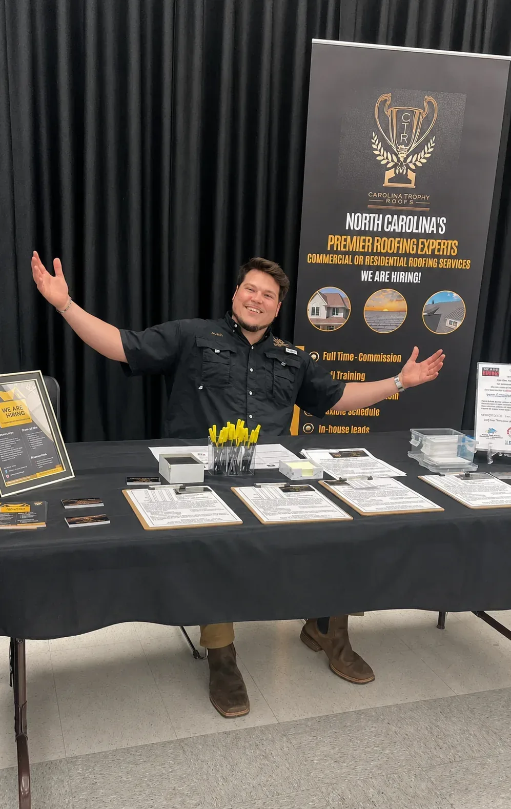 Austin at the Carolina Trophy Roofs hiring booth at a job fair