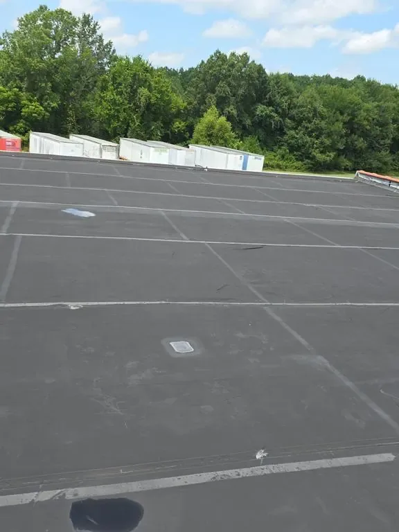 Dark EPDM rubber membrane field across a large commercial roof in Eastern North Carolina