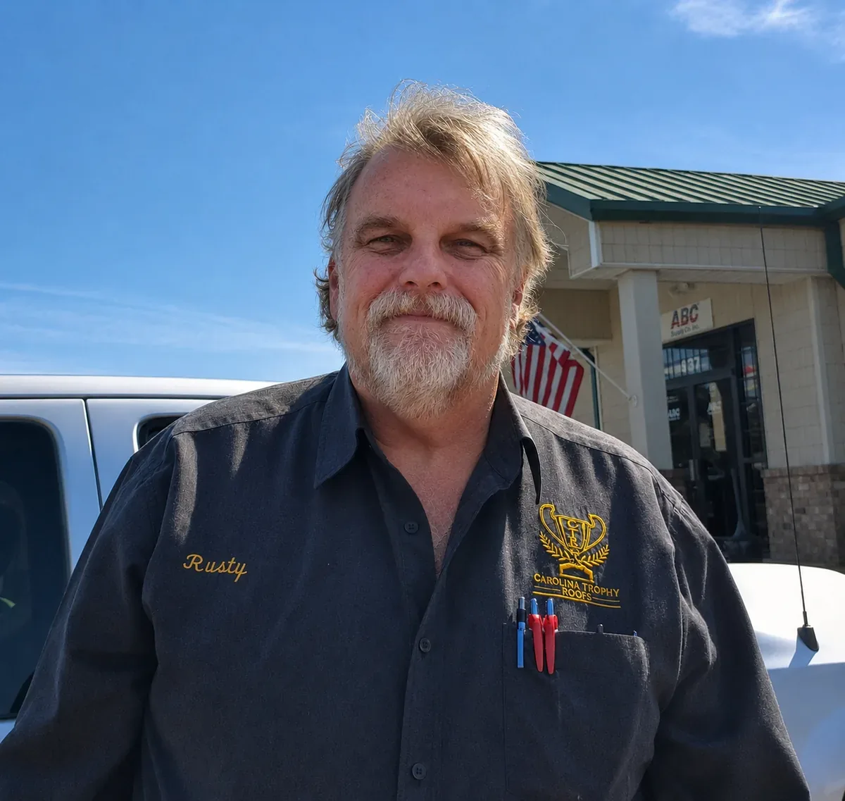 George 'Rusty' Pugh, owner and operator of Carolina Trophy Roofs, in a company work shirt at the roofing supply house