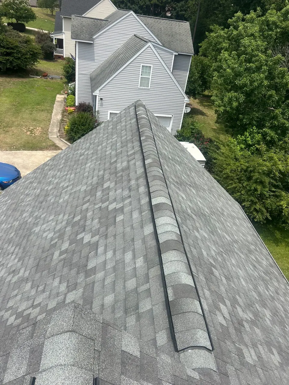 Light gray architectural shingles and ridge cap on a finished roof in Goldsboro, NC