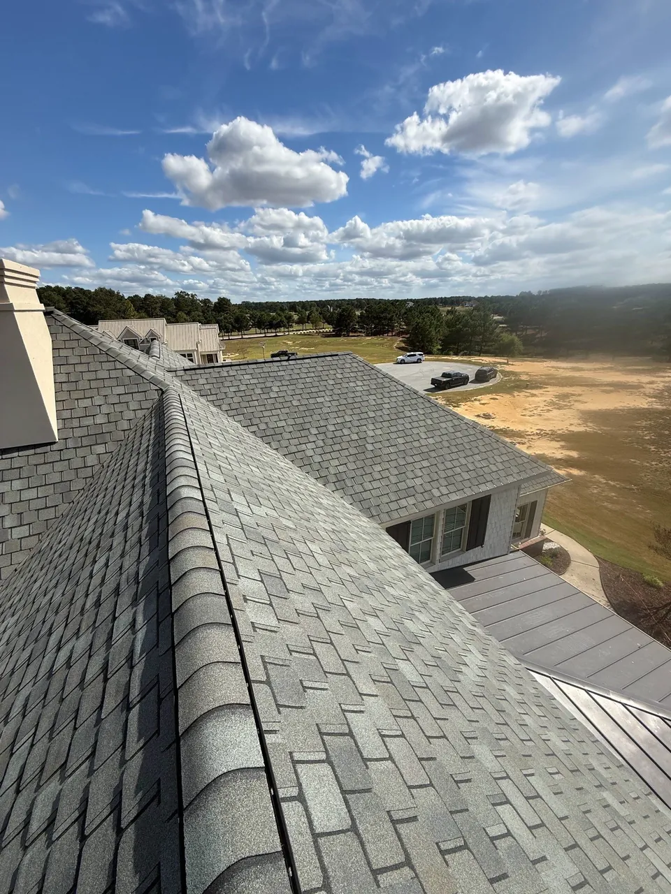 New gray ridge caps and shingles on a Snow Hill, NC home, looking out over open fields