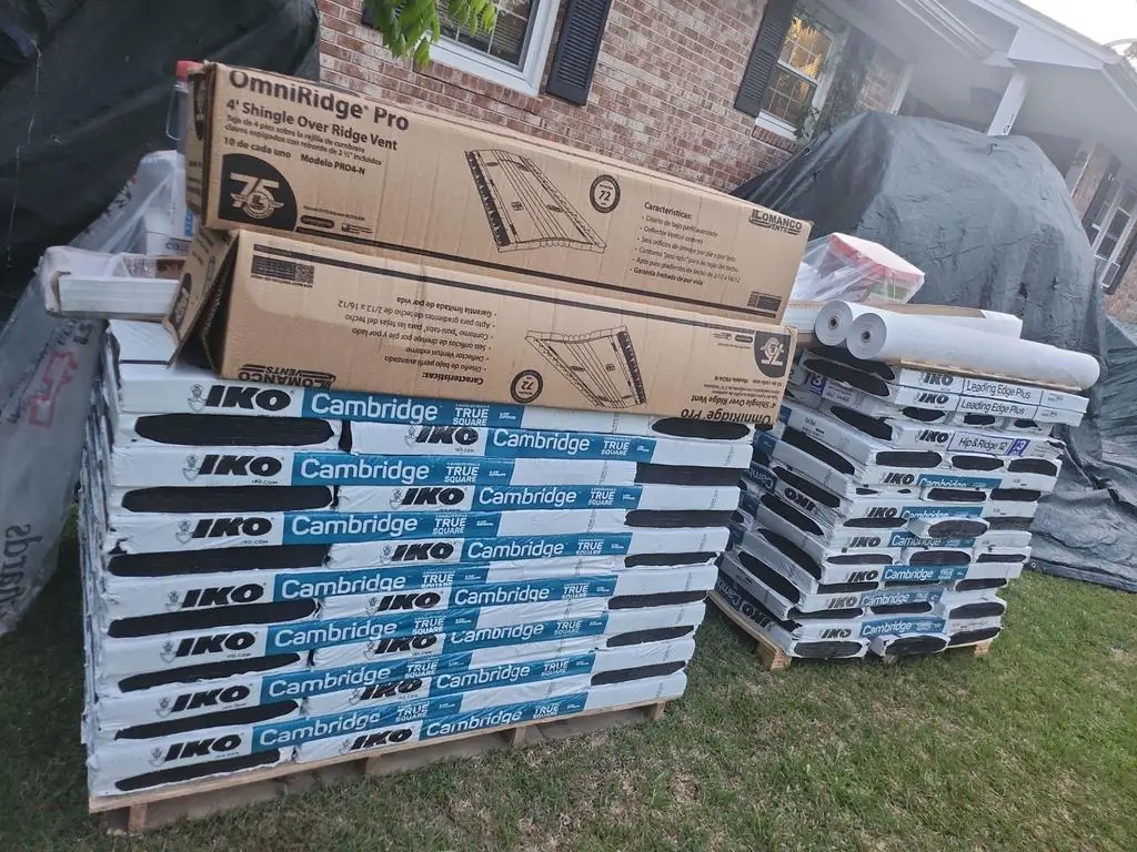 Pallets of IKO Cambridge shingles, Leading Edge Plus starter, Hip & Ridge 12 caps and an OmniRidge Pro ridge vent at a New Bern, NC job