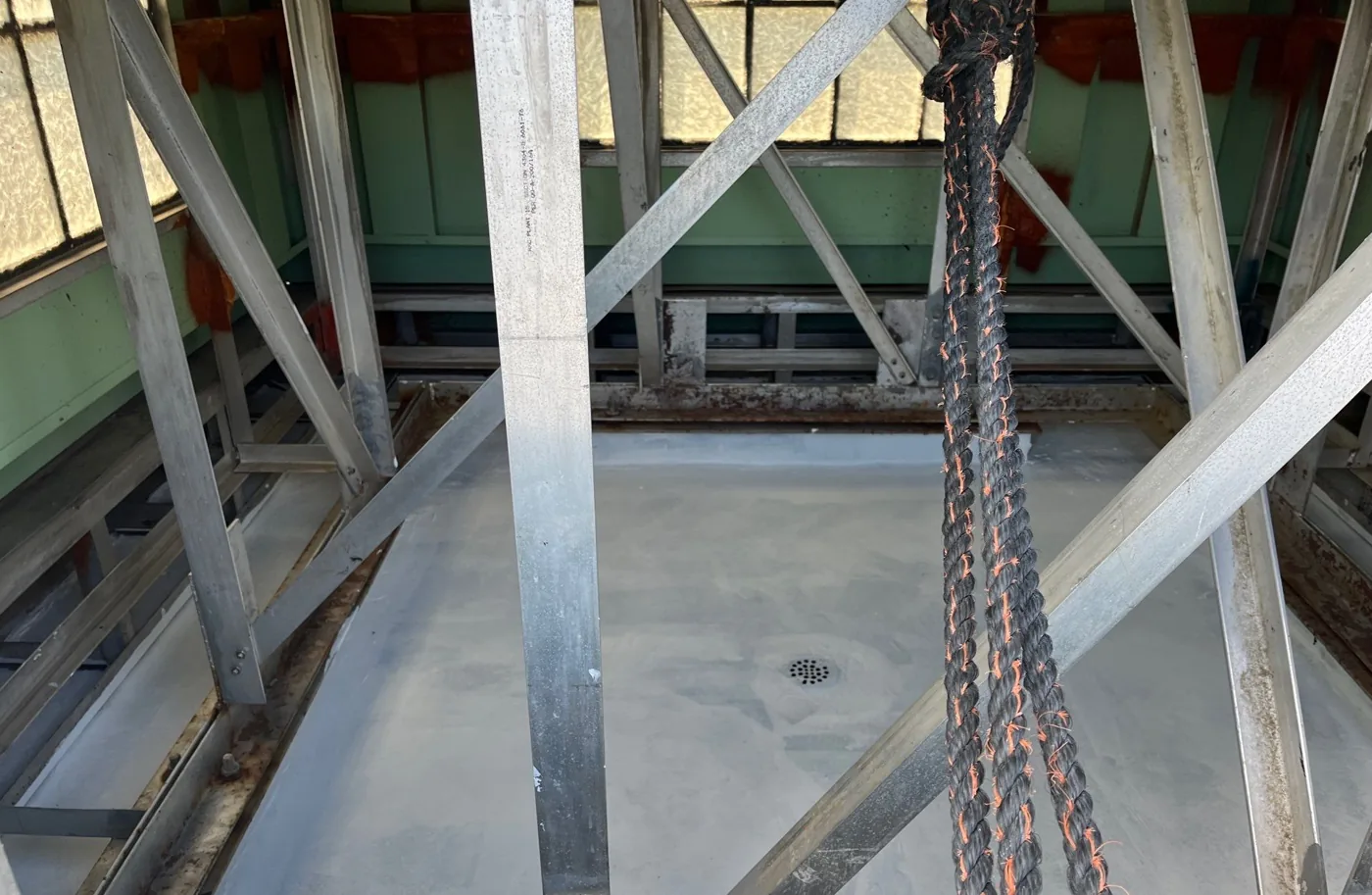 The same metal deck after sealing and recoating by Carolina Trophy Roofs, showing a clean, uniform light grey restored surface