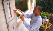 Man caulking windows